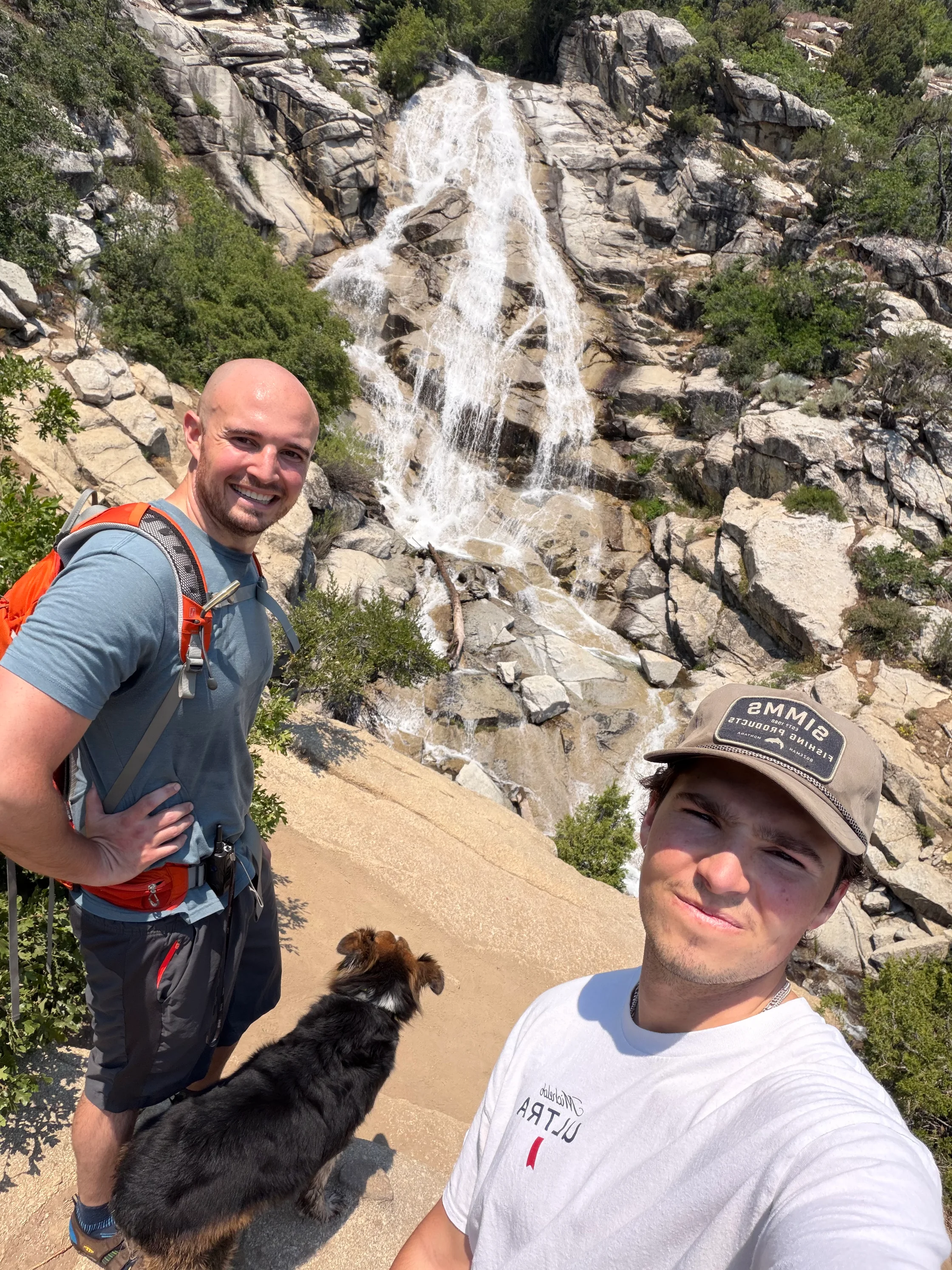 Chad, his brother Mason, and D'Artagnan on a hike above a waterfall