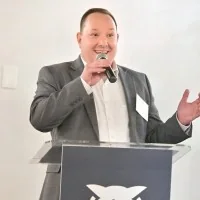 Robert Sullivan speaking at a podium