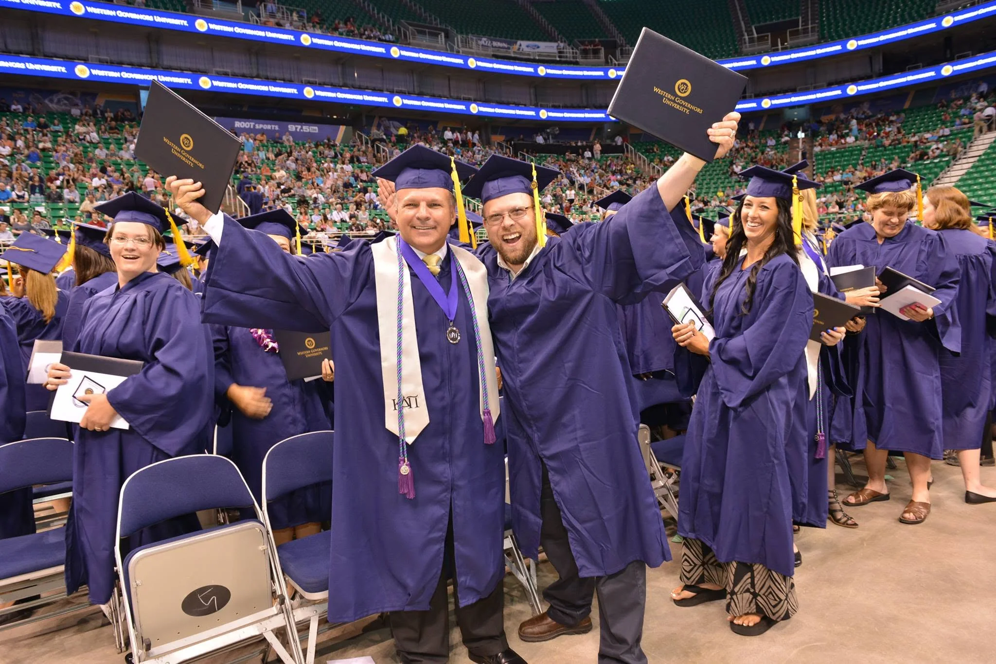 WGU graduates celebrating with their diplomas at commencement